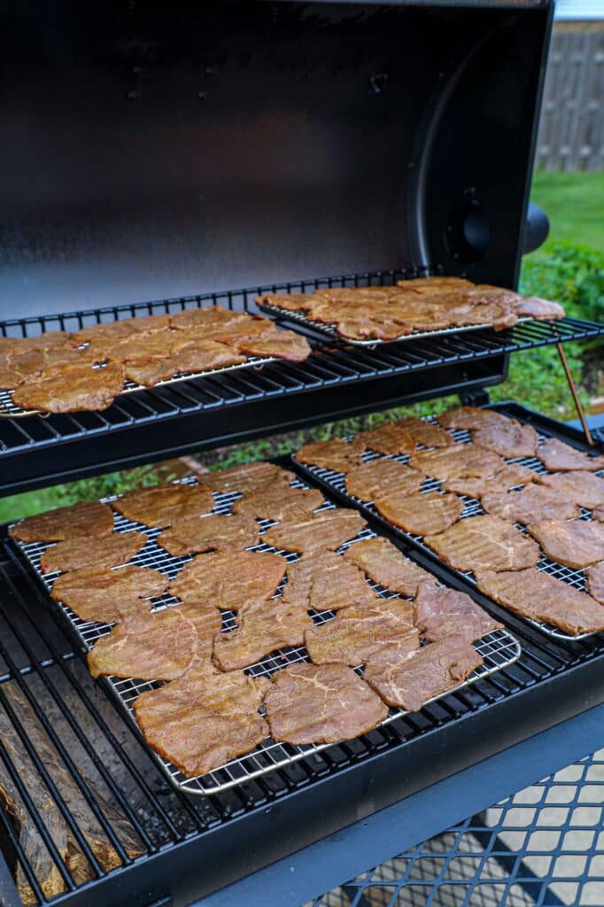 the jerky on wire racks put onto the smoker