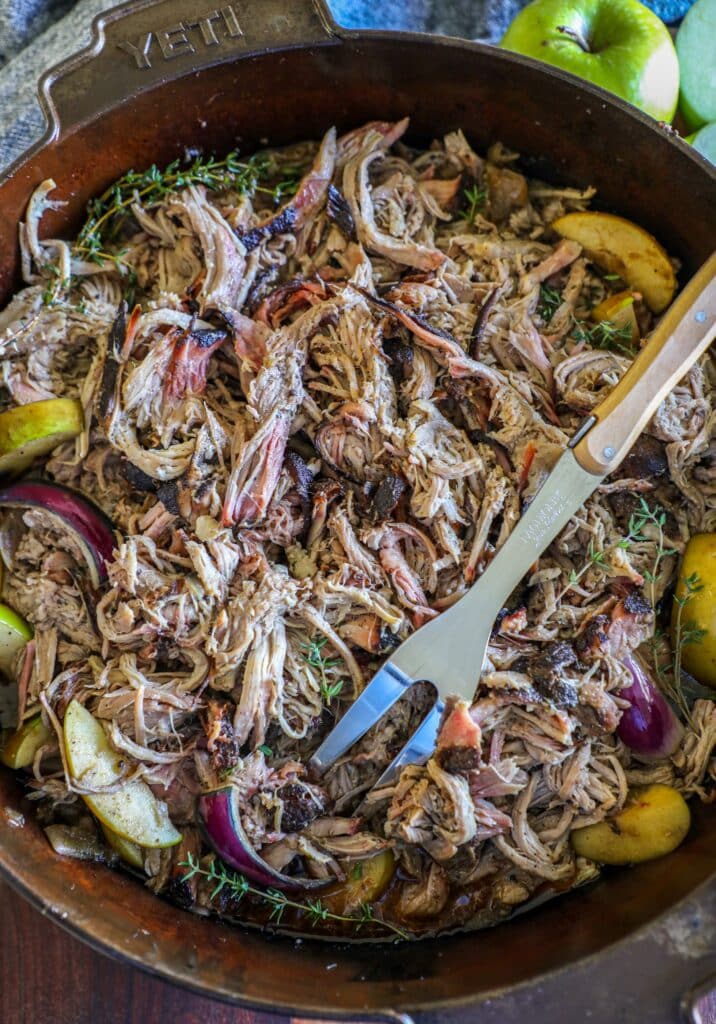 shredded apple cider pork in a large pan